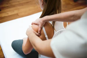 Registered massage therapist treating a patient’s shoulder